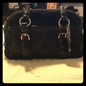 Black cloth Coach purse with large C’s.